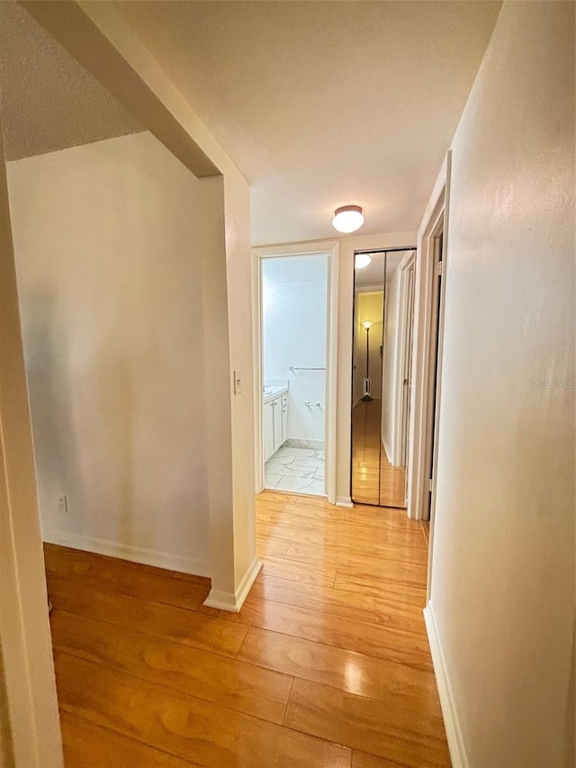 hallway with light hardwood / wood-style flooring