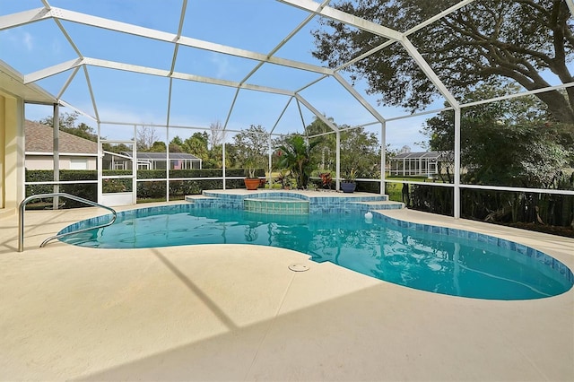 view of swimming pool featuring an in ground hot tub, a patio, and glass enclosure