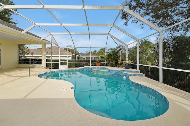 view of pool with a patio and glass enclosure