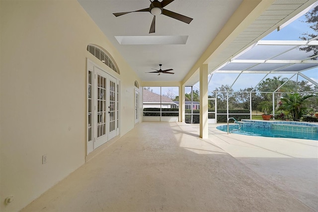 view of swimming pool with french doors, ceiling fan, a lanai, and a patio