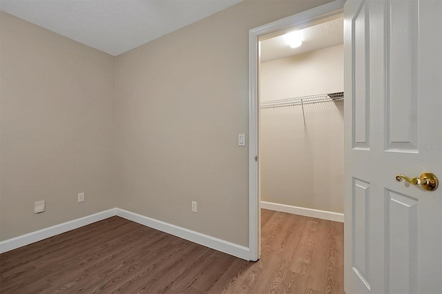 unfurnished bedroom with a closet and light hardwood / wood-style flooring