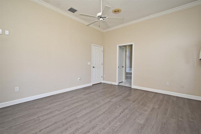 spare room featuring ceiling fan, ornamental molding, and hardwood / wood-style floors