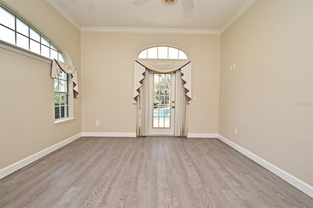 empty room with ornamental molding, ceiling fan, and light hardwood / wood-style floors