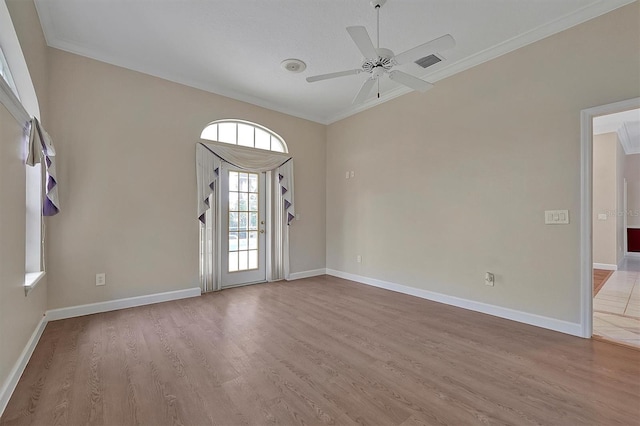 empty room with ceiling fan, ornamental molding, and light hardwood / wood-style floors