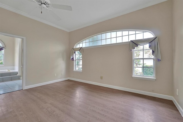 empty room featuring crown molding, hardwood / wood-style flooring, and ceiling fan