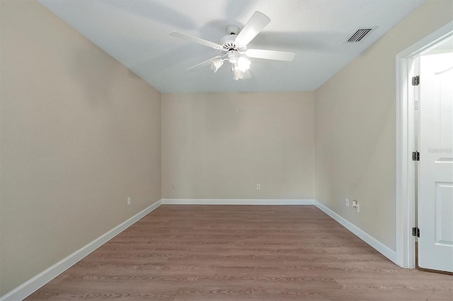 empty room featuring ceiling fan and light hardwood / wood-style flooring