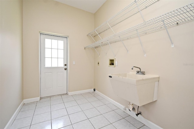 laundry room with electric dryer hookup, sink, hookup for a washing machine, and tile patterned floors