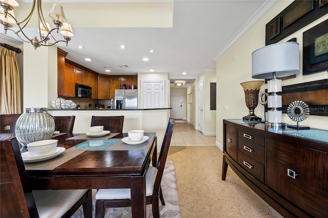 dining space with a chandelier, light tile patterned floors, and ornamental molding