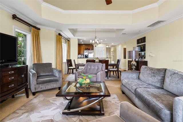 carpeted living room featuring a raised ceiling, crown molding, and a chandelier