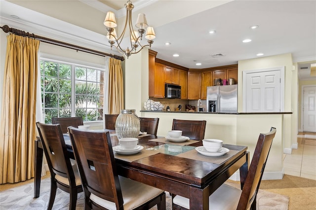 tiled dining space featuring an inviting chandelier and ornamental molding