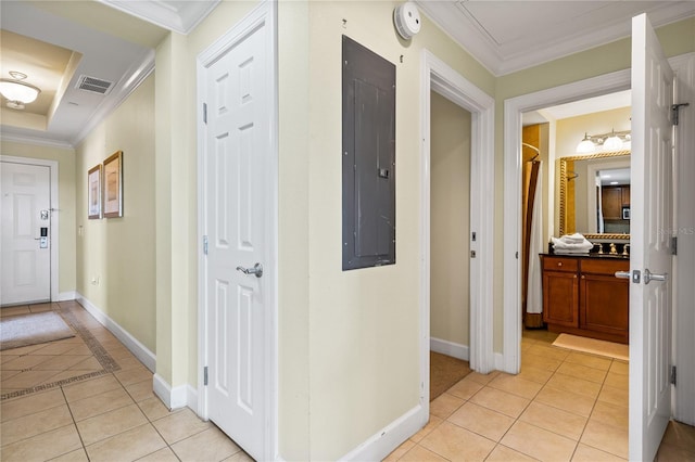 corridor with light tile patterned floors, electric panel, and ornamental molding