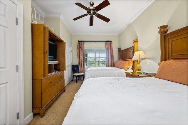 bedroom featuring ceiling fan, light carpet, and ornamental molding