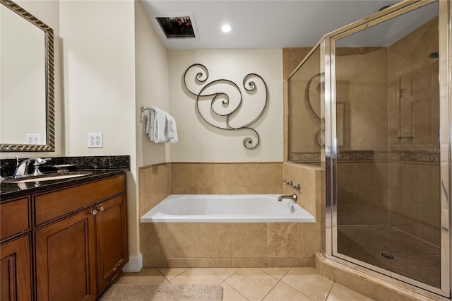 bathroom featuring tile patterned flooring, vanity, and plus walk in shower