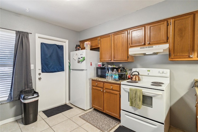 kitchen featuring white appliances and light tile patterned floors