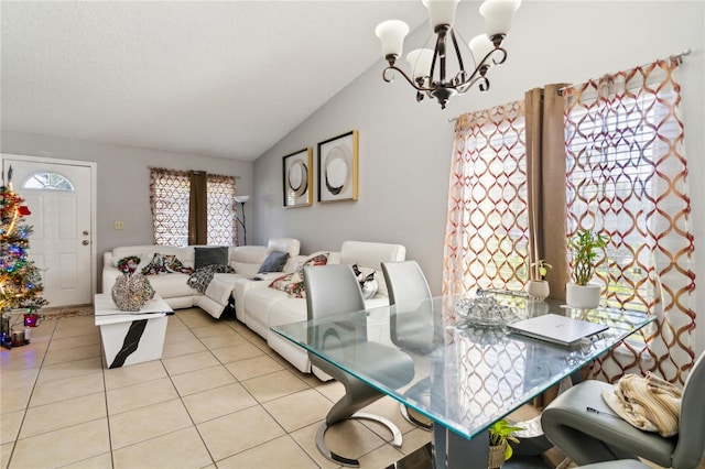 dining room with an inviting chandelier, lofted ceiling, and light tile patterned flooring