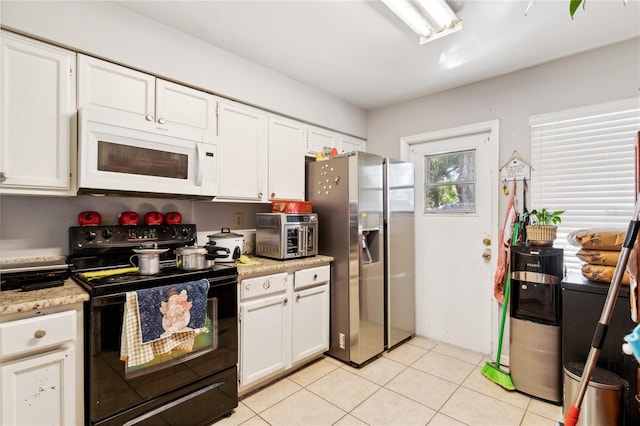 kitchen with white cabinetry, light tile patterned floors, stainless steel refrigerator with ice dispenser, and black range with electric cooktop