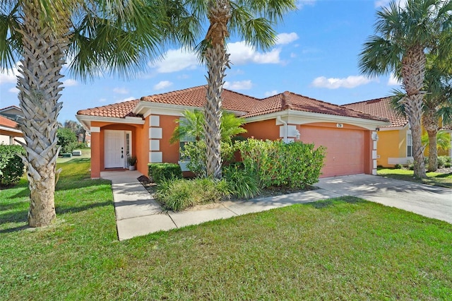 mediterranean / spanish home with a front lawn and a garage