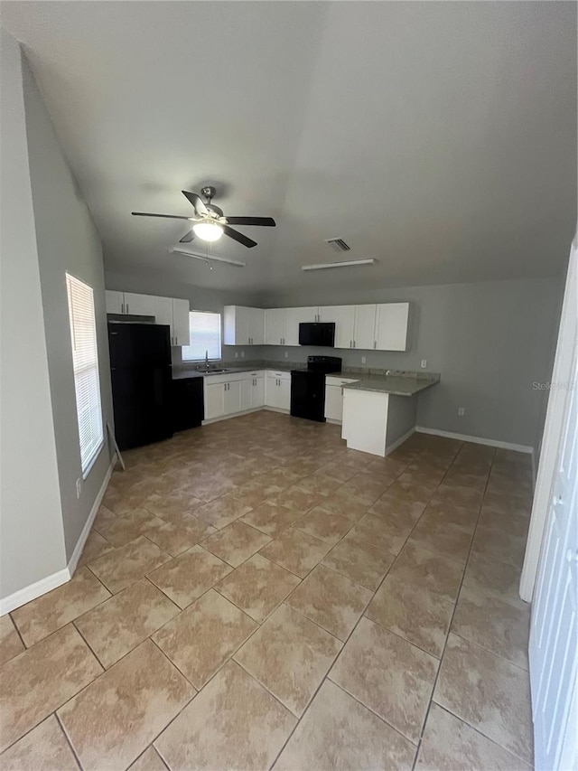 kitchen with black appliances, sink, kitchen peninsula, ceiling fan, and white cabinetry