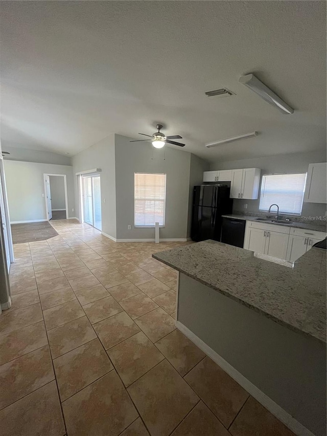 kitchen featuring ceiling fan, sink, light stone counters, white cabinets, and black appliances