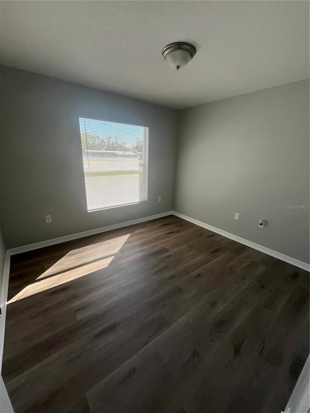 unfurnished room featuring dark hardwood / wood-style floors