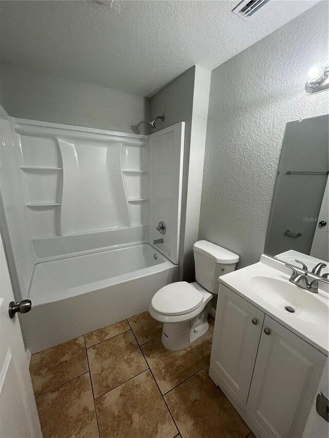 6336 Florida Cir, Apollo Beach, FL 33572 - bathroom featuring toilet, vanity, a textured wall, a textured ceiling, and bathing tub / shower combination