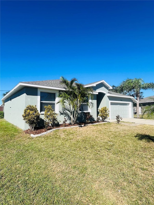 single story home featuring a garage and a front lawn