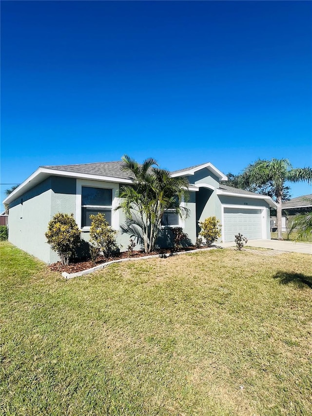 6336 Florida Cir, Apollo Beach, FL 33572 - view of front facade featuring stucco siding, a garage, a front lawn, and concrete driveway