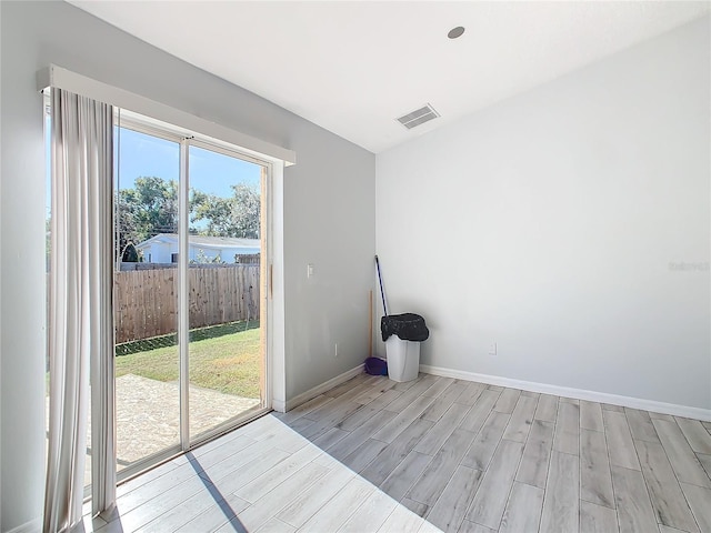 unfurnished room with light hardwood / wood-style flooring