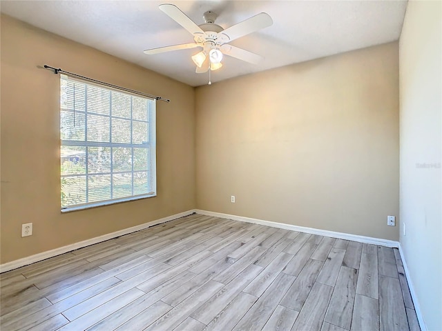 spare room with light hardwood / wood-style floors and ceiling fan