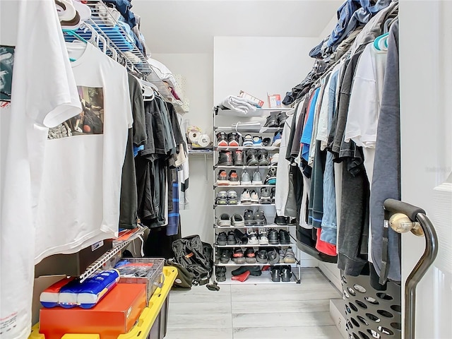 spacious closet with light hardwood / wood-style floors