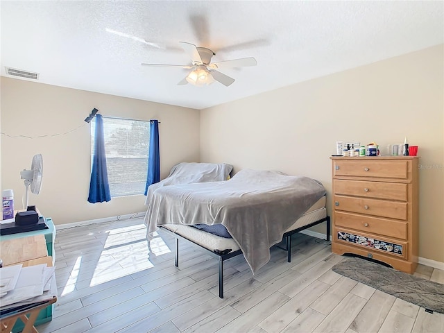 bedroom with ceiling fan and light hardwood / wood-style floors