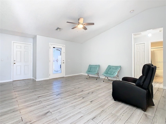 sitting room featuring ceiling fan, light wood-type flooring, and lofted ceiling