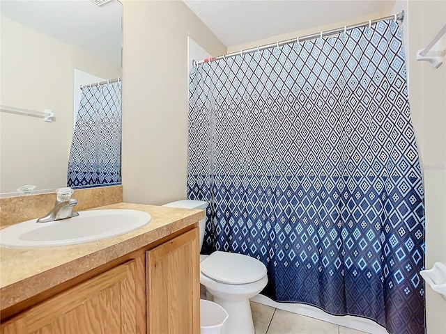 bathroom featuring tile patterned floors, vanity, and toilet