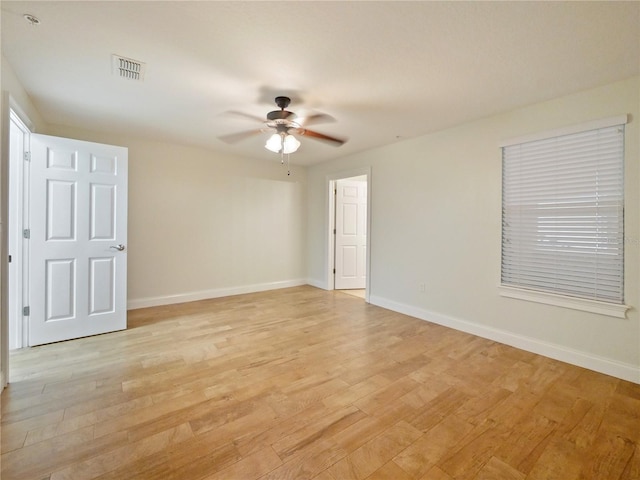 empty room featuring ceiling fan and light hardwood / wood-style flooring