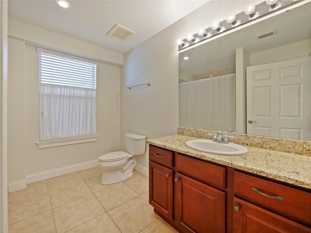 bathroom featuring tile patterned flooring, vanity, a shower with shower curtain, and toilet