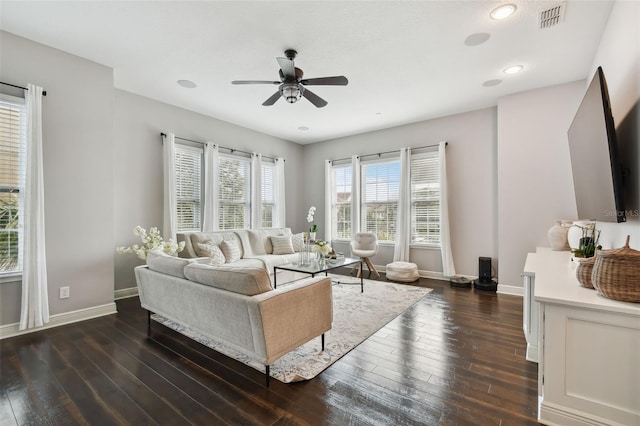 living room featuring ceiling fan and dark wood-type flooring