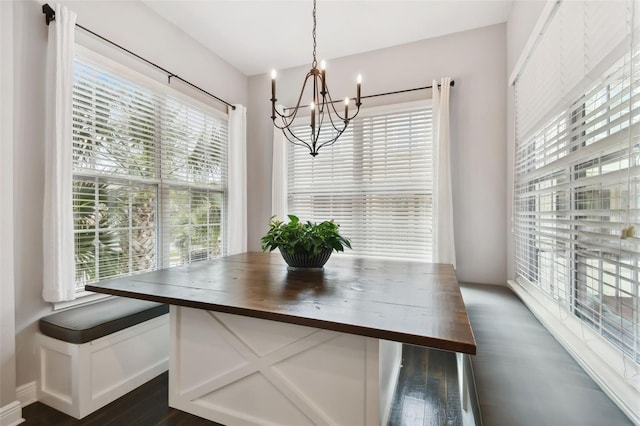 dining space featuring a notable chandelier, dark hardwood / wood-style floors, and a wealth of natural light