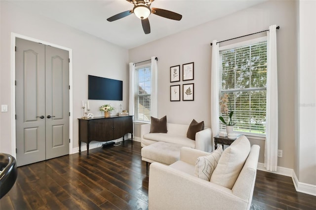 living room featuring a wealth of natural light and dark wood-type flooring