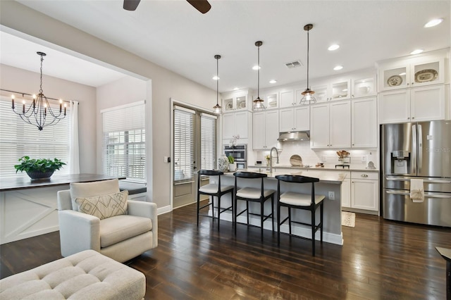 kitchen with white cabinets, pendant lighting, dark hardwood / wood-style flooring, and appliances with stainless steel finishes