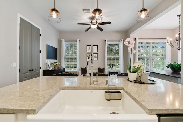 kitchen with pendant lighting and a healthy amount of sunlight