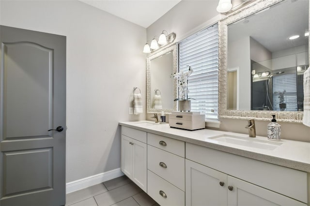 bathroom with tile patterned floors, vanity, and walk in shower