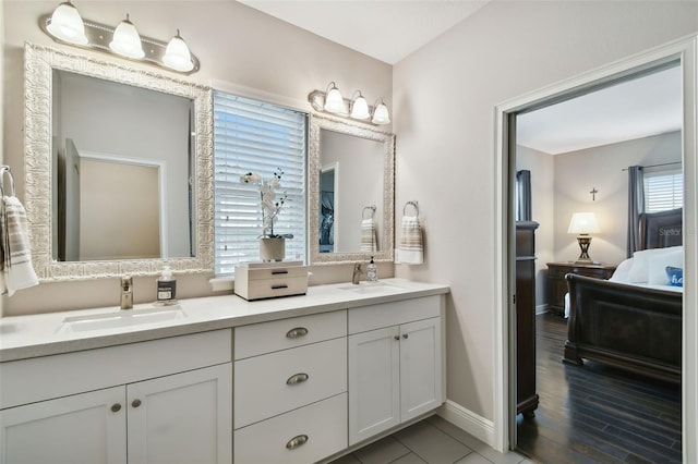 bathroom with hardwood / wood-style floors, vanity, and a healthy amount of sunlight