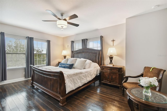 bedroom with dark hardwood / wood-style flooring and ceiling fan