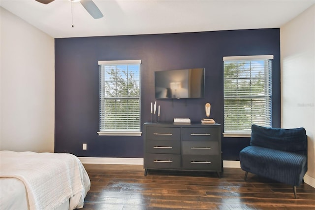 bedroom with dark hardwood / wood-style flooring and ceiling fan