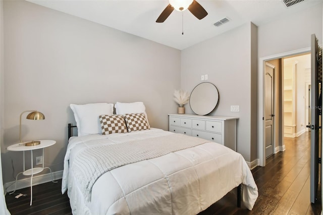 bedroom with ceiling fan and dark hardwood / wood-style flooring