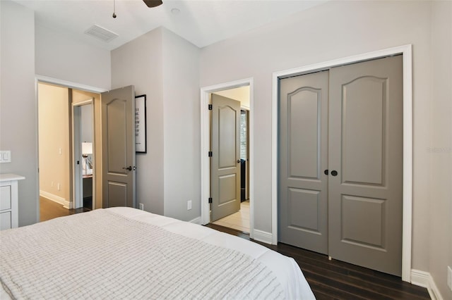 bedroom featuring dark hardwood / wood-style flooring, a closet, and ceiling fan