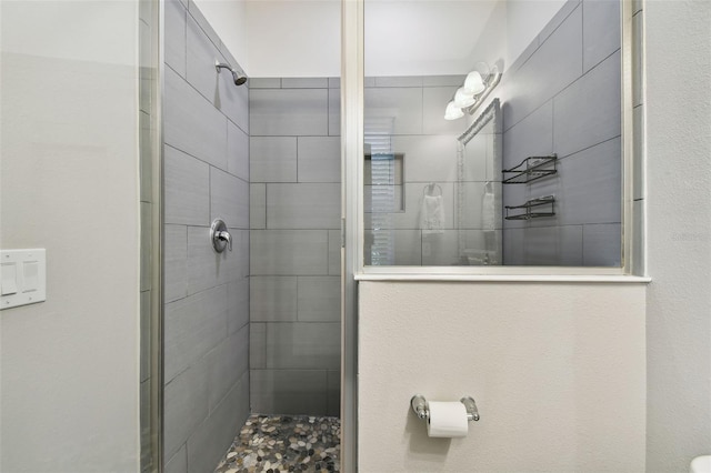 bathroom with a tile shower