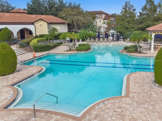 view of swimming pool featuring a patio area