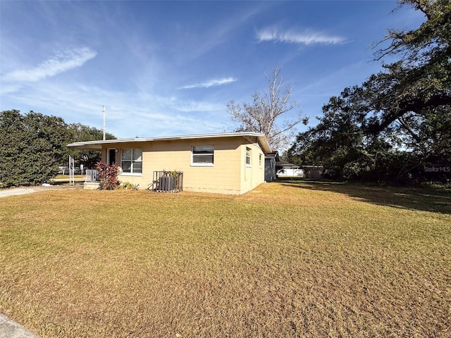 exterior space with a lawn and cooling unit