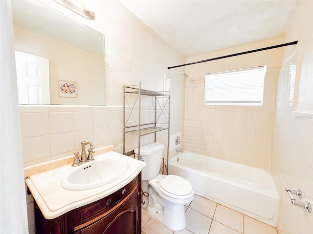 full bathroom featuring vanity, tile walls, tile patterned flooring, toilet, and tiled shower / bath